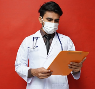 Doctor looking at clipboard